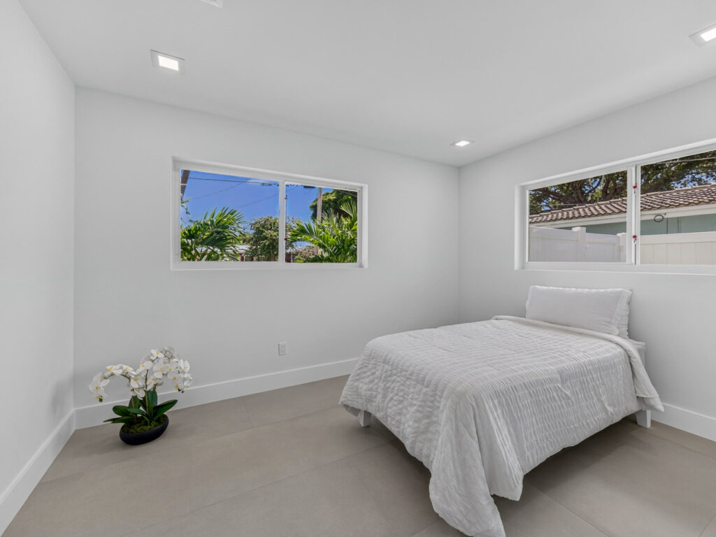 Bedroom with two windows and a wall-mounted mini-split