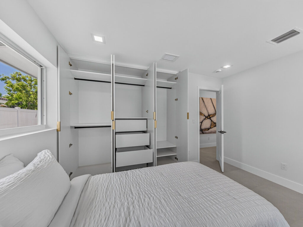 Bedroom closet built out with shelving and hanging space