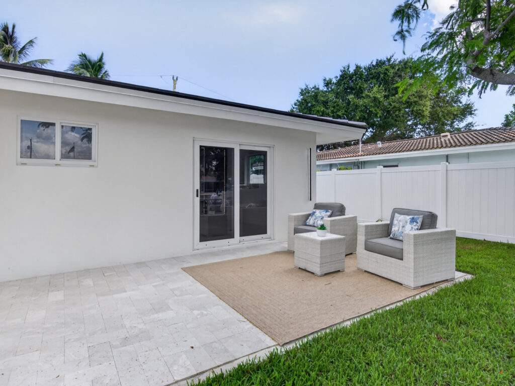 Travertine patio with lounge seating off the rear of the house
